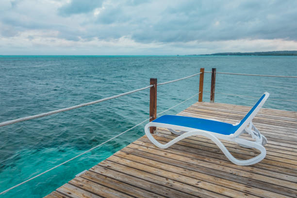 istock Wooden Pier and Long Blue Chairs with Nobody 921367970
