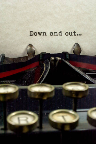 istock Antique typewriter with saying down and out 921371306