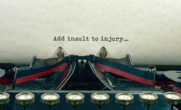 istock Antique typewriter with saying add insult injury 921371330