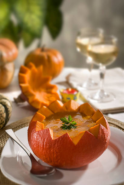 istock Soup inside of cut pumpkin with spoon, plate, and white wine 92137842