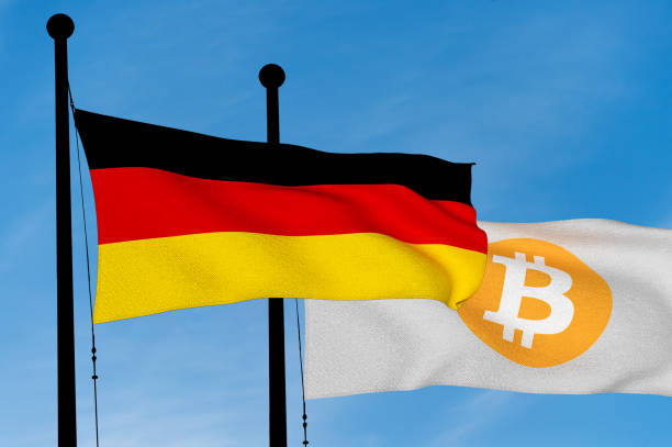 istock German flag and Bitcoin Flag waving over blue sky (3D rendering) 921386818
