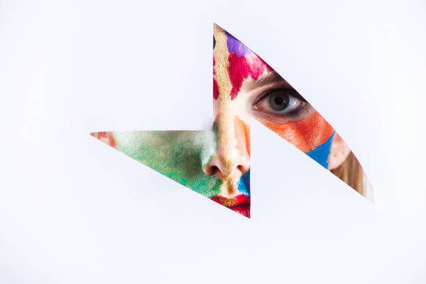 istock Beautiful female eye looking through the paper hole 921392170