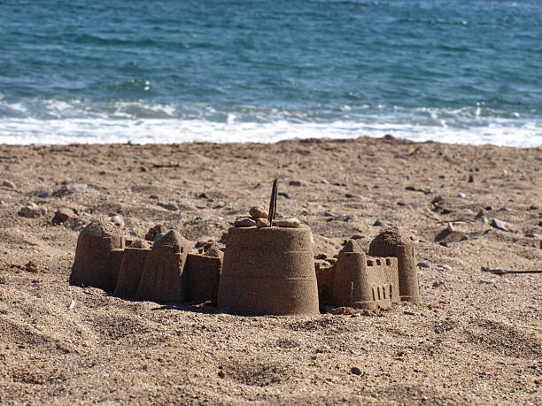 istock sand castle on the beach with ocean in background 92141354