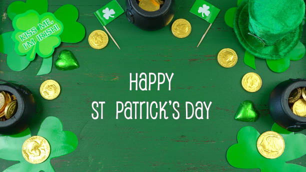istock St Patrick's Day leprechaun hat with decorations on green rustic background 921432150