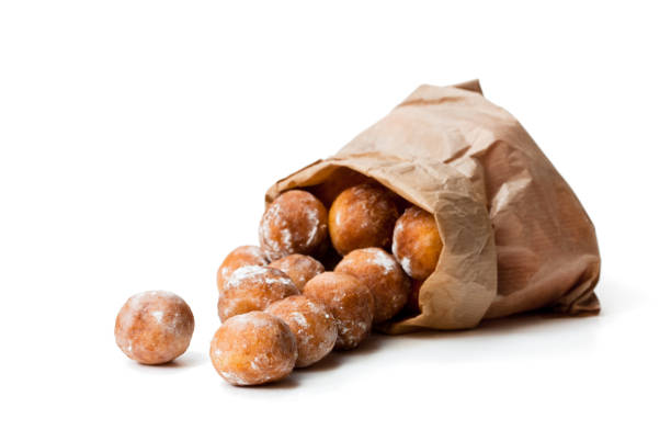istock Mini  doughnuts in paper bag isolated on white 921432304