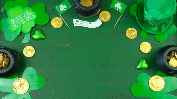 istock St Patrick's Day leprechaun hat with decorations on green rustic background 921432348