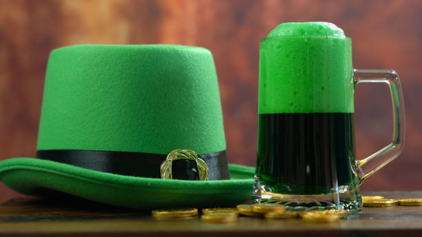 istock St Patrick's Day pouring green beer with green leprechaun hat 921432374