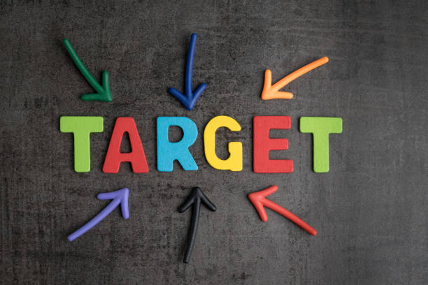 istock Business aiming target plan for success concept, multi colorful magnet arrows pointing at wooden letters the word TARGET at the center on chalkboard loft cement wall 921436912