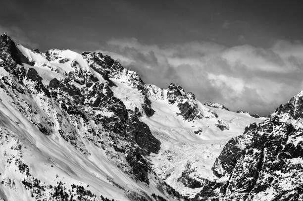 istock Black and white mountains with glacier in snow at winter sun day 921436980