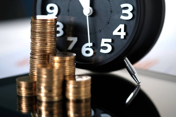 istock Step of coins stacks and alarm clock with tablet computer and financial graph, business planning vision and finance analysis concept. 921437436