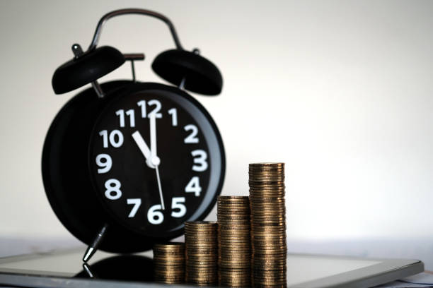 istock Step of coins stacks and alarm clock with tablet computer and financial graph, business planning vision and finance analysis concept. 921437458