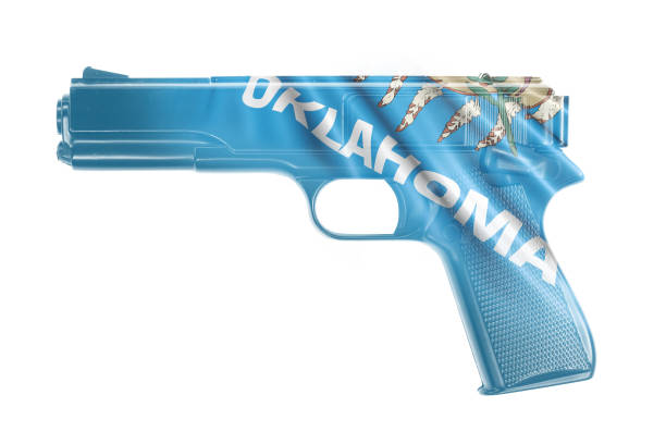 istock Gun wrapped in the Oklahoma state flag 921437910
