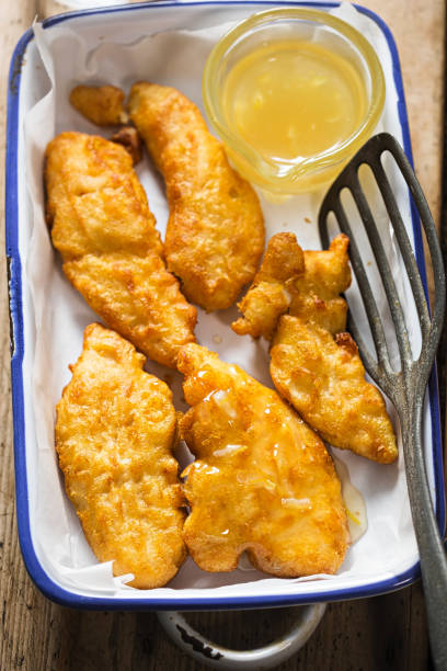 istock Crispy lemon chicken. Battered mini chicken fillets with fresh & tangy lemon sauce 921438050