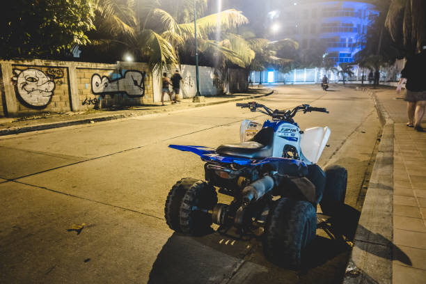 Four Wheelers and Motorcycles are a common Transportation Vehicle. Here is a 4x4 Parked in the Street at Night. SAN ANDRES ISLAND, Colombia _ Circa March 2017. Four Wheelers and Motorcycles are a common Transportation Vehicle. Here is a 4x4 Parked in the Street at Night. motorcycle 4 wheels stock pictures, royalty-free photos & images