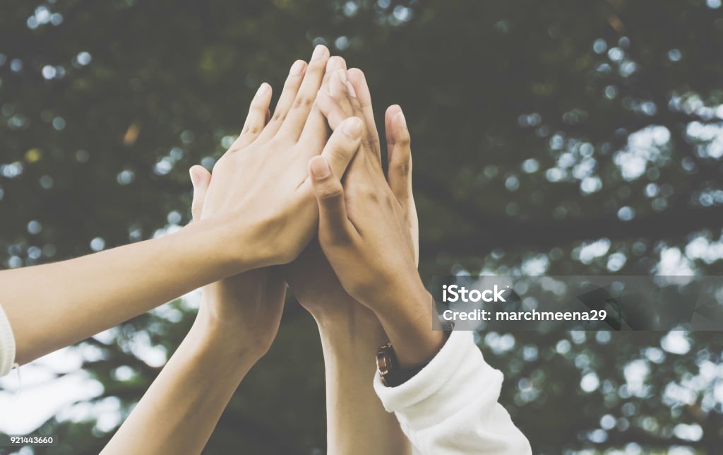 Team work and together concept, Hand of people high five for tag team Volunteer Stock Photo