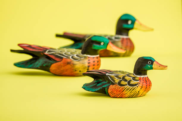 istock Hand Made Wooden Ducks for Home Decoration on Yellow Background 921456408