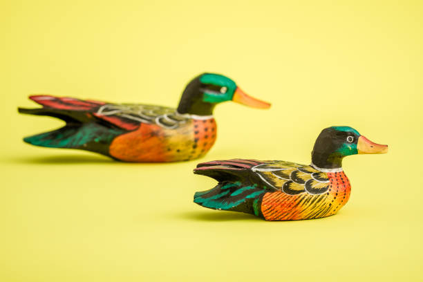 istock Hand Made Wooden Ducks for Home Decoration on Yellow Background 921456774