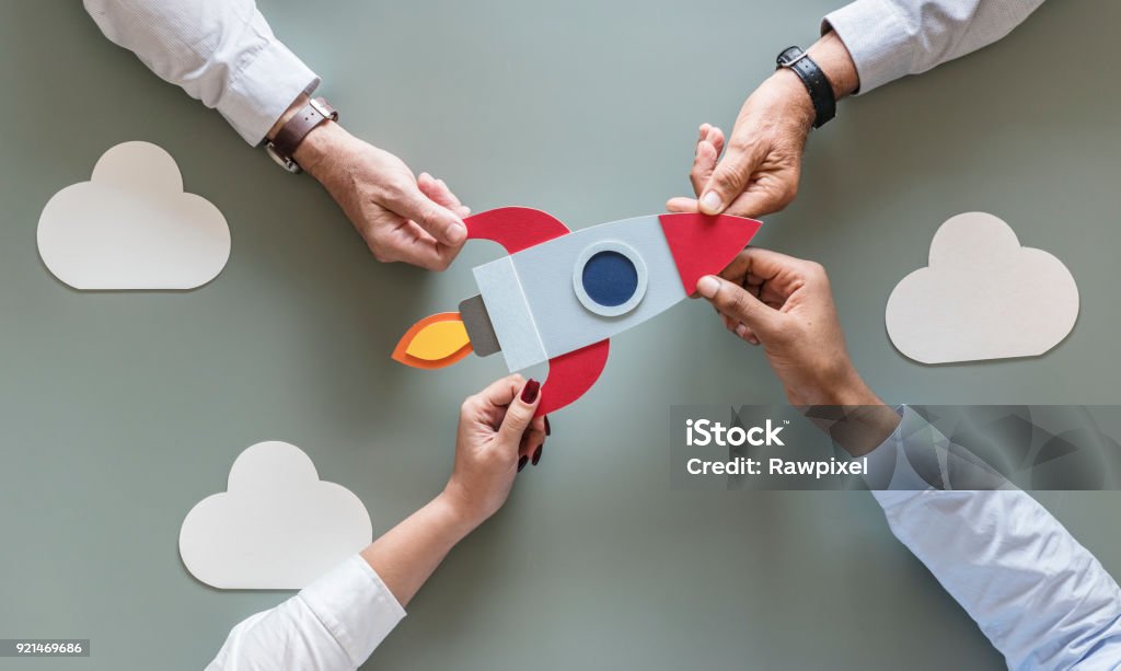 Business people with startup rocket New Business Stock Photo