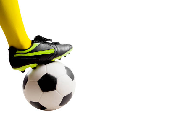 istock soccer player feet kicking soccer ball 921475286