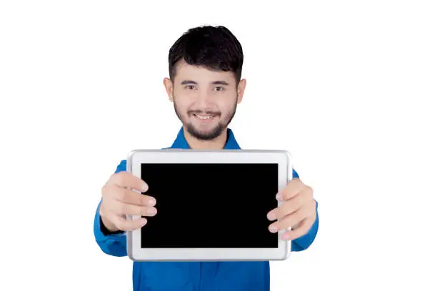 Young friendly mechanic holding digital tablet with copy space over white background