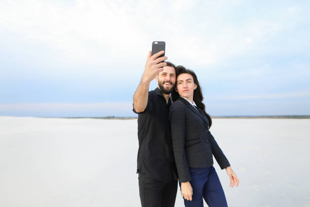 istock boyfriend and girlfriend testing front-camera in new smar 921480640
