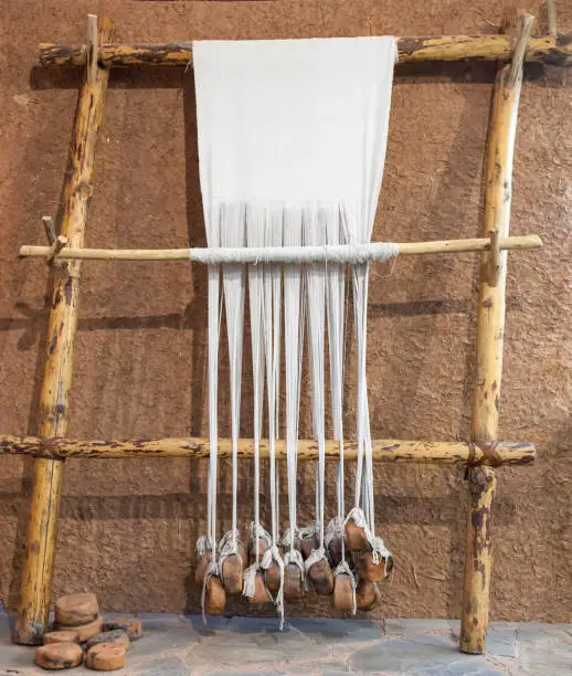 Reconstructed prehistoric age weaving loom. Mudwall ancient house replica