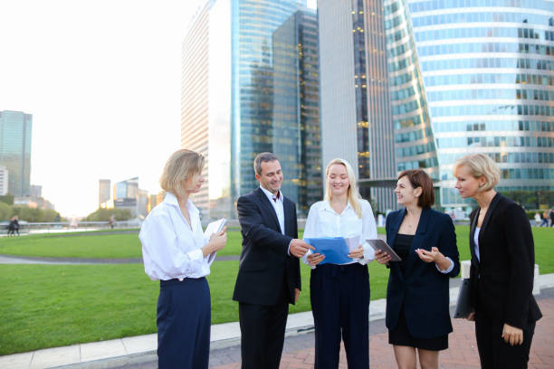 istock Biz partners advising and calling by smartphone outside 921483662