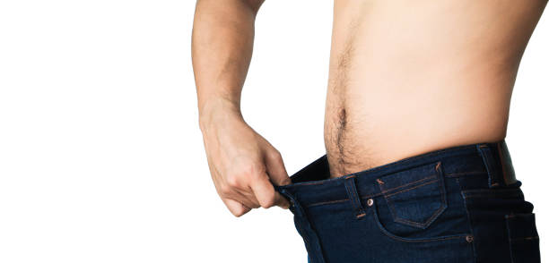 istock man in blue jeans try to loss weight 921486264