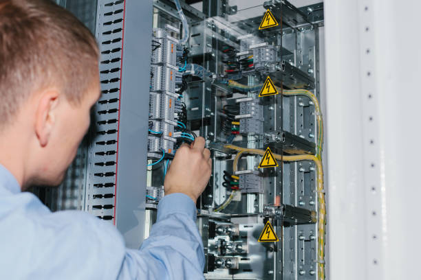 istock Electrician specialist checking low-voltage cabinet equipment 921493498