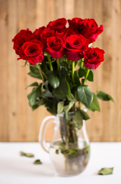 istock Beautiful Red Valentines Roses on a Wooden Table 921493920