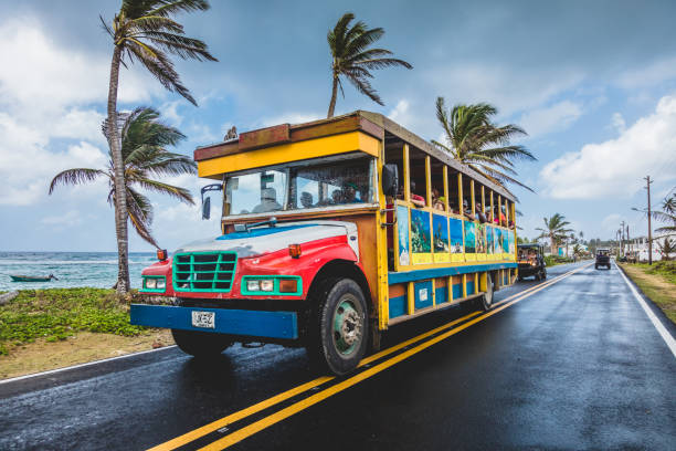 Colorful Public Transportation Bus doing the Round Trip All Around the Island. All kind of Vehicles use this Route stock photo
