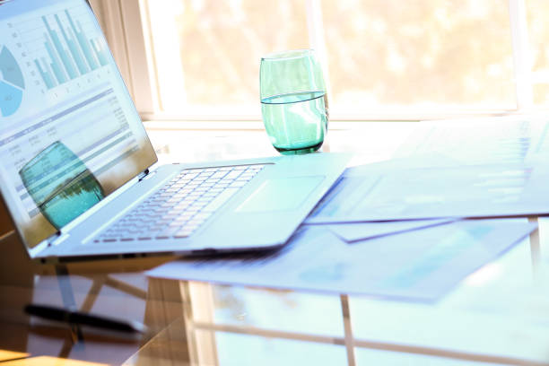 istock working place with laptop, digital tablet; graphs at the office 921504228