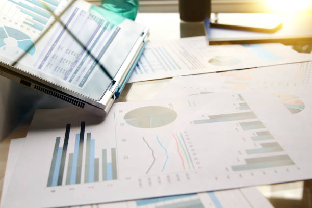 istock working place with laptop, digital tablet; graphs at the office 921504274