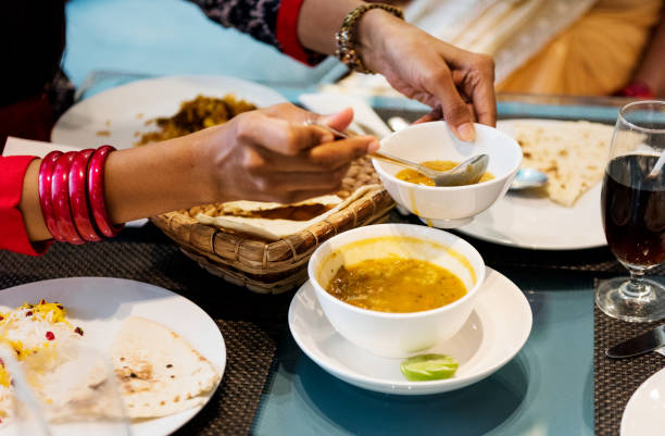 Family having Indian food Family having Indian food sri lankan culture stock pictures, royalty-free photos & images