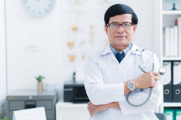 istock Older Asian doctor Working in the examination room 921509158