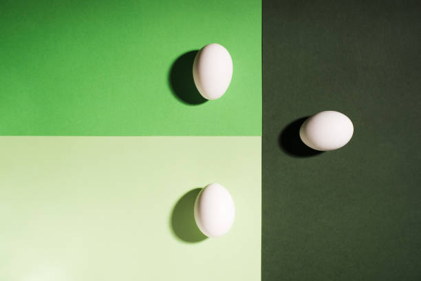 istock Three white easter eggs on three shades of green 921516168