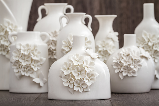 Different decorative white vases with 3d flower and butterfly designs