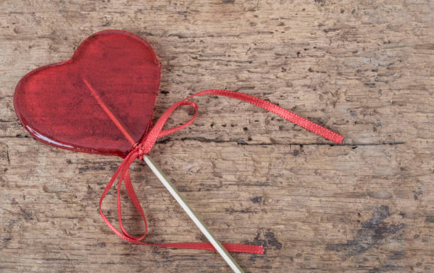 istock heart shaped red candy on wooden background with copy space 921532208