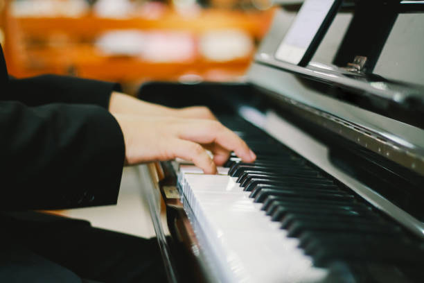 istock Soft focus, blurr Playing piano with light sunset background.and instagram style filter photo vintage tone 921559814