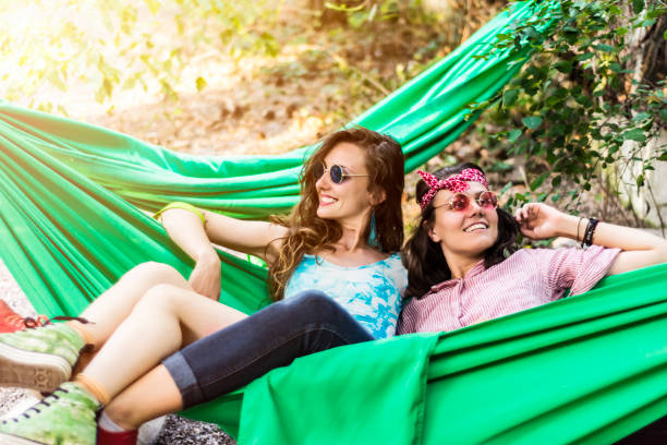 istock Young cheerful women in a hammock 921559876