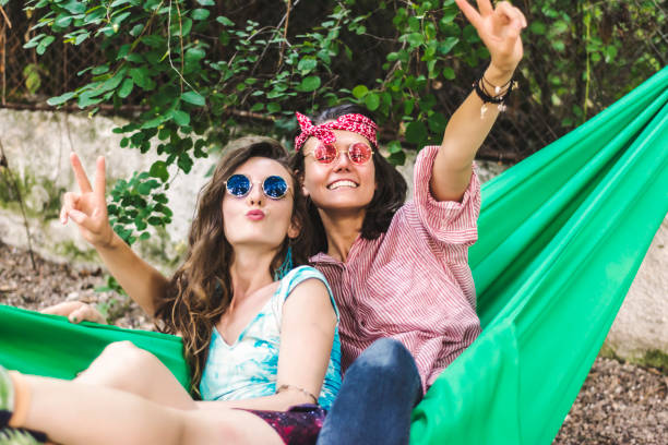 istock Young cheerful women in a hammock 921559878