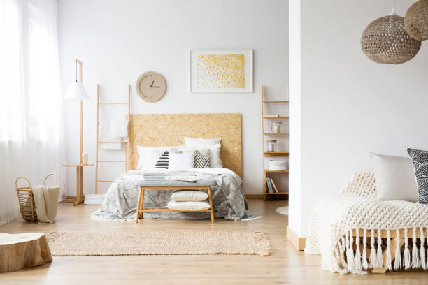 istock Spacious bohemian bedroom with wood 921560524