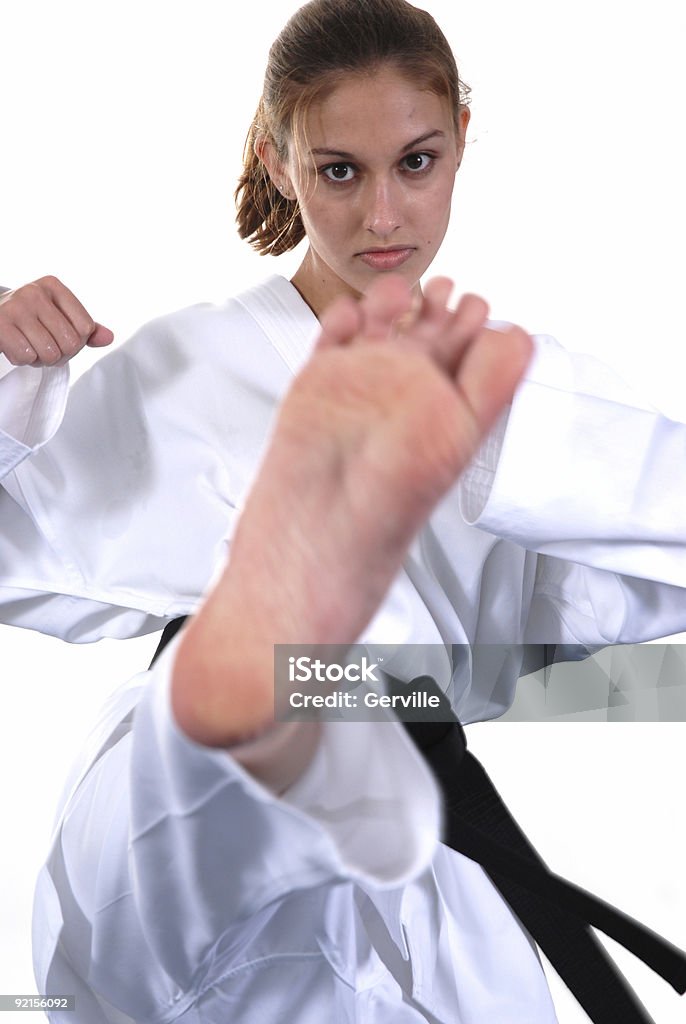 One to the head Martial artist kicking high. Human Face Stock Photo