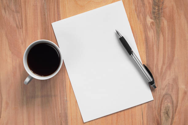 istock Coffee and clean paper with a pen 921565232