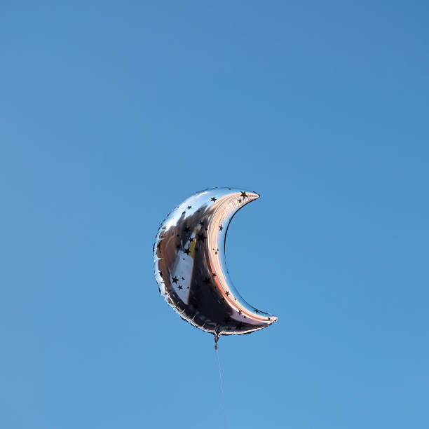 istock Moon shape Balloons in the sky 921567428