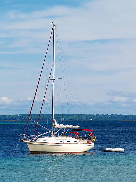 sailboat anchored in harbor stock photo