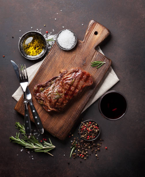 istock Grilled ribeye beef steak with red wine, herbs and spices 921574262