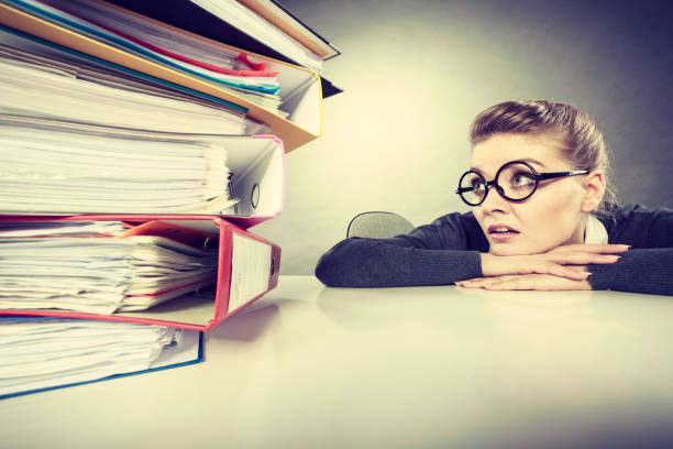 istock Accountant terrified of pils of binders. 921574588