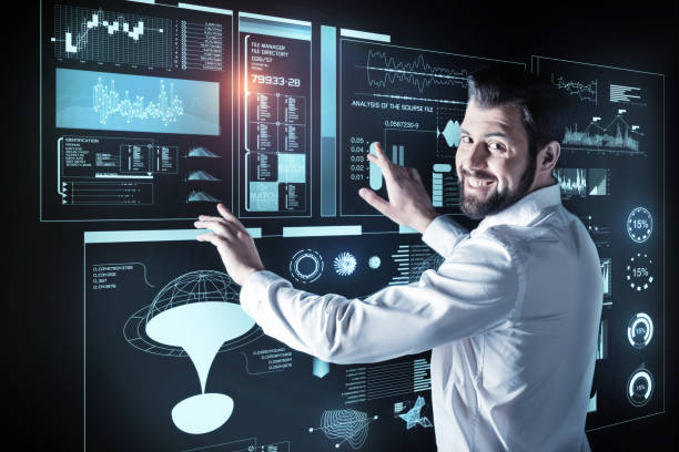 istock Happy man touching a futuristic screen and looking glad 921580714