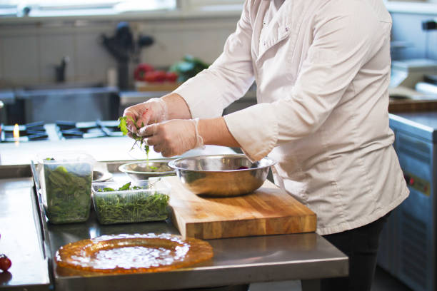 istock Chef preparing a salad in the kitchen of the restaurant 921581592